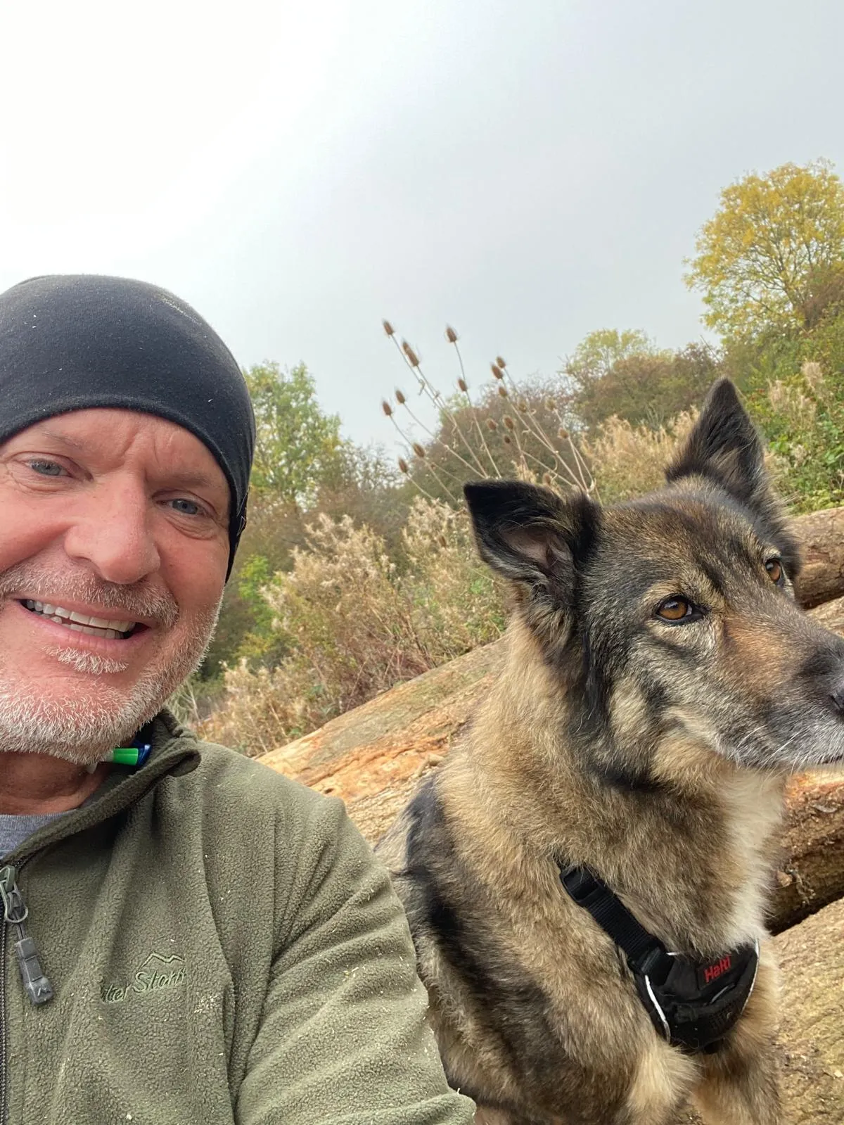 A man and a dog are posing for a picture.